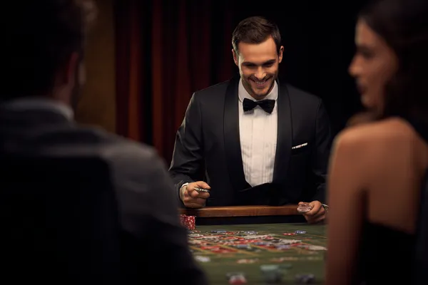 A woman in a luxurious green gown next to an ornate roulette wheel, capturing the upscale casino mood of 778G0.